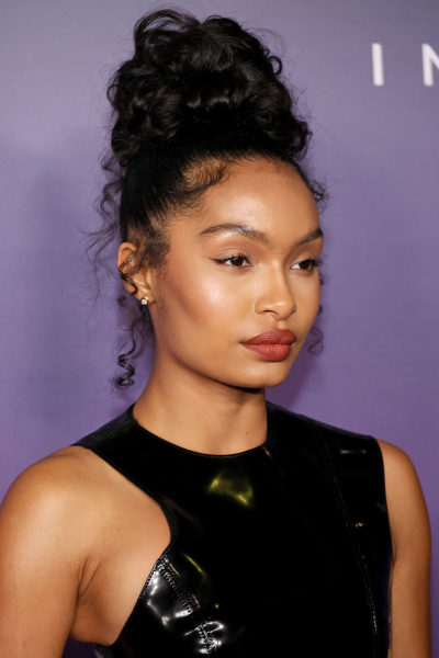 Yara Shahidi wearing a loose curly bun hairstyle